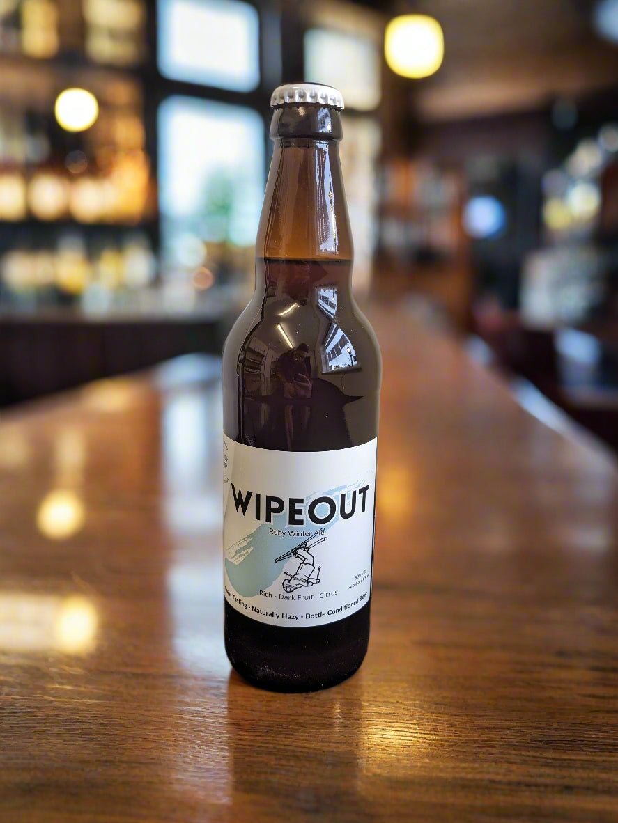 Brown beer bottle with cap. Wipeout Ruby Ale. Great Tasting Naturally Hazy Bottle Conditioned Beer