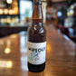 Brown beer bottle with cap. Wipeout Ruby Ale. Great Tasting Naturally Hazy Bottle Conditioned Beer