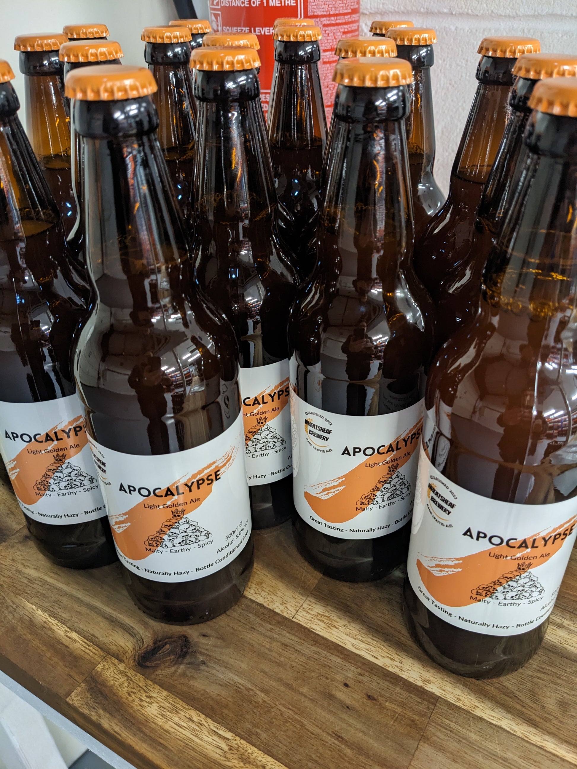 Apocalypse malty, earthy, spicy golden ale in bottles with orange caps. Great Tasting naturally hazy bottle conditioned beer brewed in Huntingdon UK
