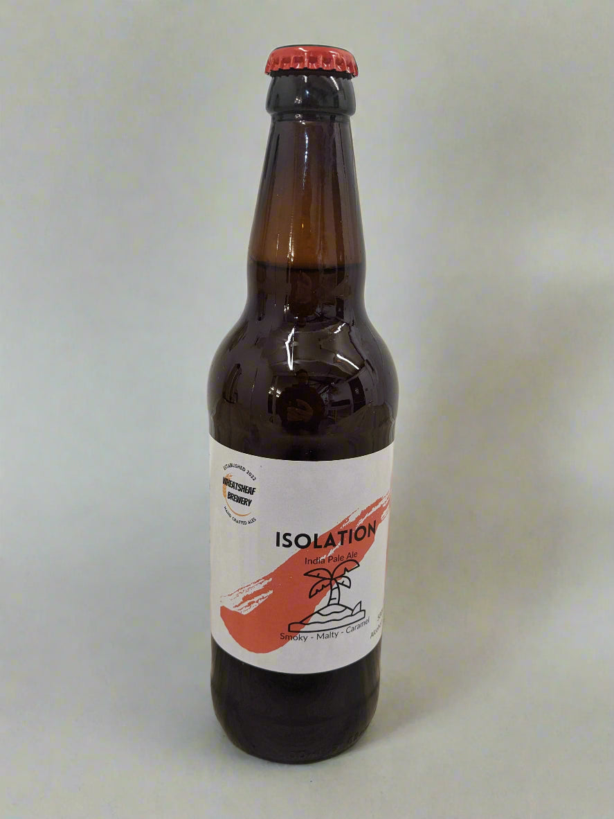 Isolation Smoky IPA in bottle with a red cap. Label shows a desert island with palm tree on a red paint stripe. Isolation smoky IPA, real ale brewed locally in Huntingdon UK